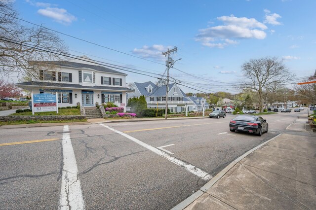 view of road with sidewalks, street lights, and curbs