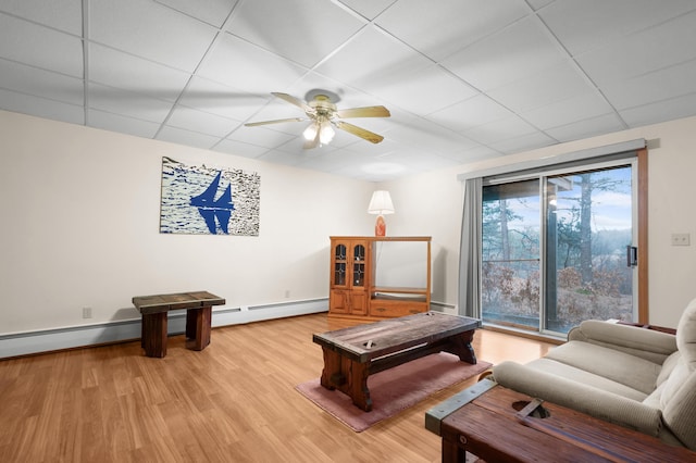 recreation room featuring a baseboard radiator, a paneled ceiling, ceiling fan, and light hardwood / wood-style floors