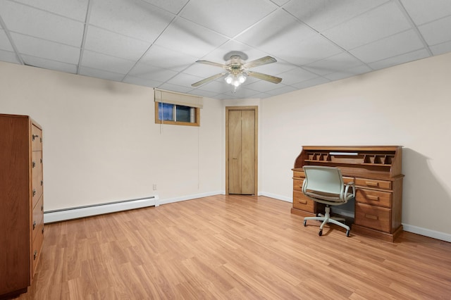 office featuring ceiling fan, light hardwood / wood-style floors, a drop ceiling, and a baseboard heating unit