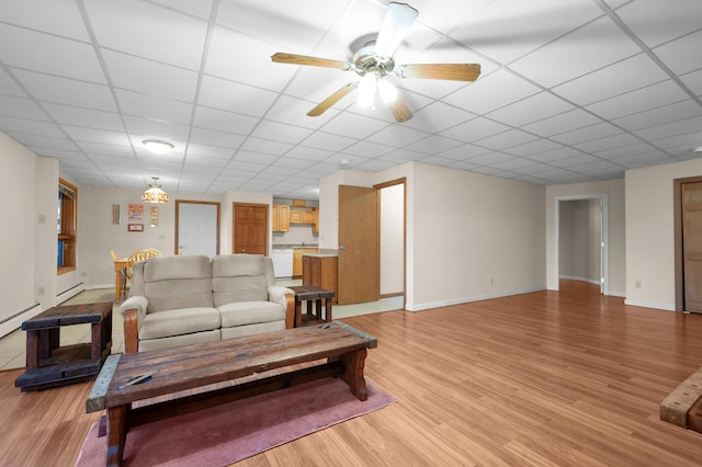 living room featuring a drop ceiling, light hardwood / wood-style floors, and ceiling fan