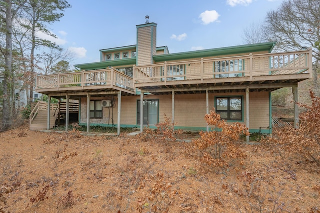 rear view of house featuring a deck