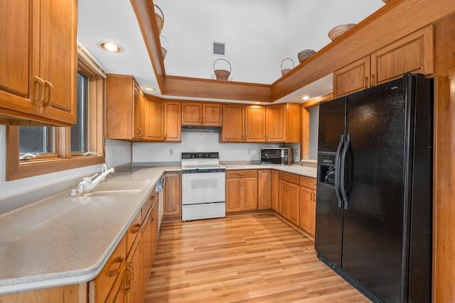 kitchen featuring white electric stove, ventilation hood, sink, light wood-type flooring, and black refrigerator with ice dispenser