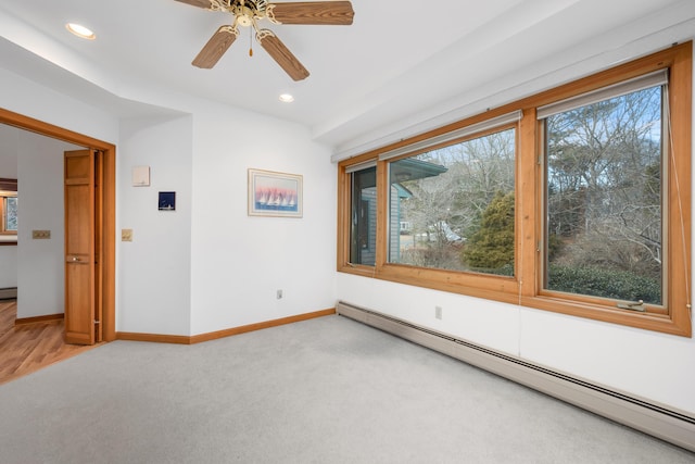 unfurnished room featuring ceiling fan, a baseboard radiator, and carpet flooring