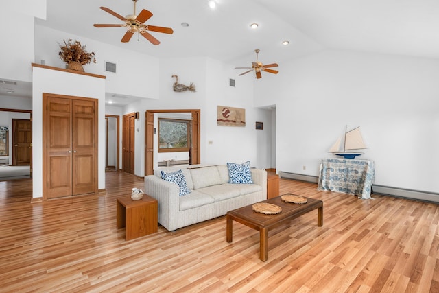 living room featuring high vaulted ceiling, a baseboard radiator, and light hardwood / wood-style floors