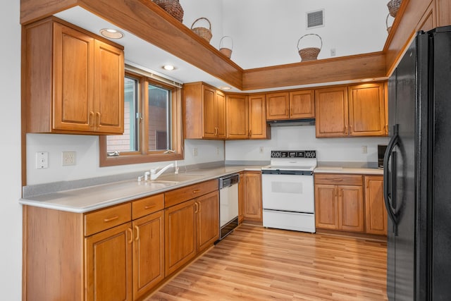 kitchen featuring black fridge, stainless steel dishwasher, electric stove, light hardwood / wood-style floors, and exhaust hood