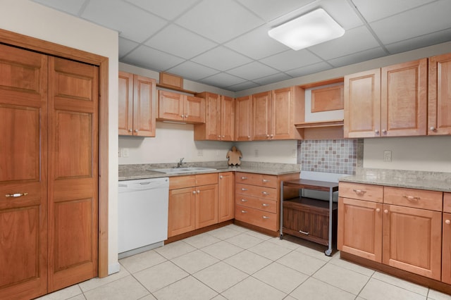 kitchen with a drop ceiling, sink, decorative backsplash, and dishwasher