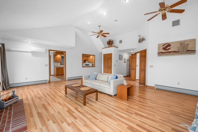 living room with a wall mounted air conditioner, light hardwood / wood-style flooring, and a baseboard heating unit