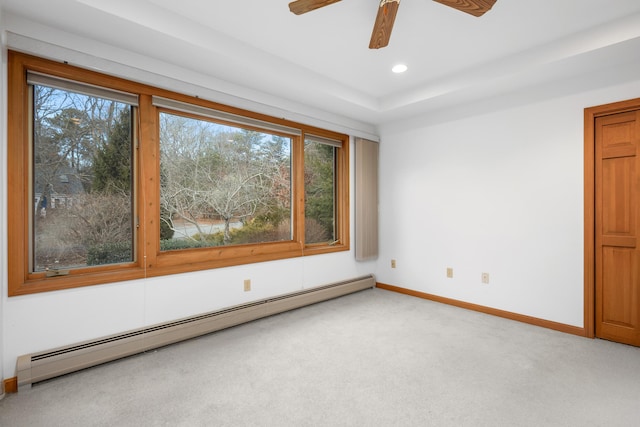 carpeted spare room with baseboard heating and ceiling fan