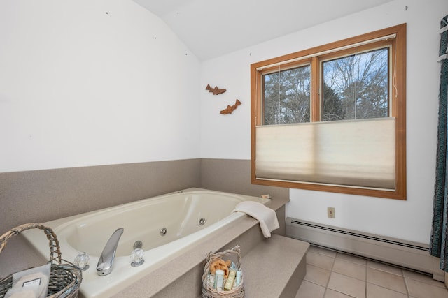 bathroom with a baseboard radiator, tile patterned floors, a bathing tub, and vaulted ceiling