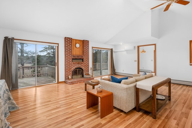 living room featuring plenty of natural light, a fireplace, and light hardwood / wood-style flooring