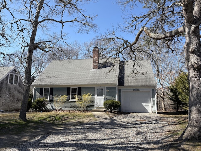 18 Russo Rd, West Yarmouth, MA 02673 - view of front of house featuring gravel driveway, a chimney, and an attached garage