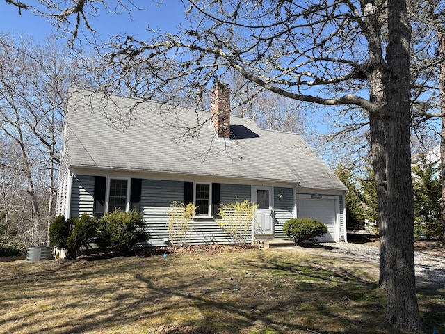 18 Russo Rd, West Yarmouth, MA 02673 - view of front of home featuring a front yard, central AC, a chimney, and an attached garage