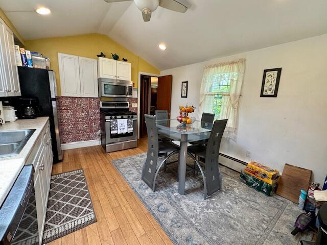 56 Wendward Way W, Yarmouth, MA 02673 - dining area featuring lofted ceiling, light wood-style floors, ceiling fan, and a baseboard radiator