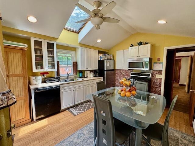 56 Wendward Way W, Yarmouth, MA 02673 - kitchen with appliances with stainless steel finishes, a ceiling fan, light wood-style flooring, vaulted ceiling, and a sink