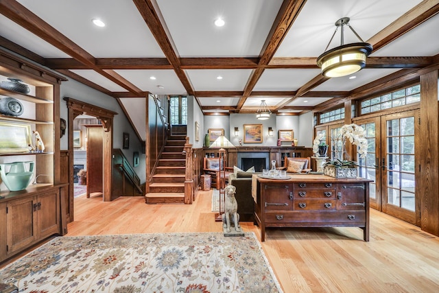 living room featuring light wood finished floors, a fireplace, beam ceiling, french doors, and coffered ceiling