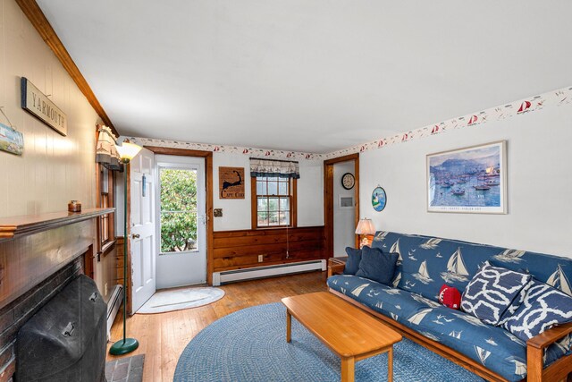 52 Nauset Rd, West Yarmouth, MA 02673 - living room featuring baseboard heating, hardwood / wood-style floors, and a fireplace