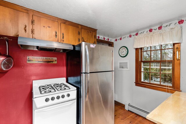 52 Nauset Rd, West Yarmouth, MA 02673 - kitchen featuring a baseboard heating unit, under cabinet range hood, white range with gas stovetop, freestanding refrigerator, and light wood-style floors