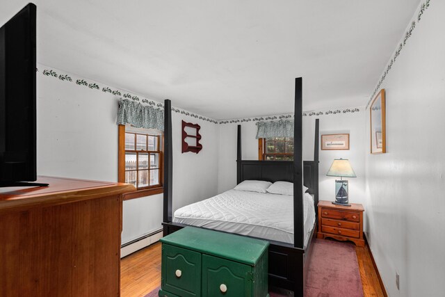52 Nauset Rd, West Yarmouth, MA 02673 - bedroom featuring light wood-style flooring and a baseboard radiator