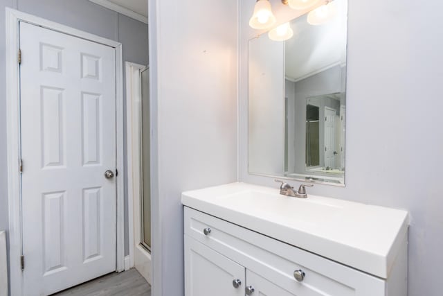 248 Mattapoisett Rd, Acushnet, MA 02743 - full bath featuring an enclosed shower, ornamental molding, wood finished floors, and vanity