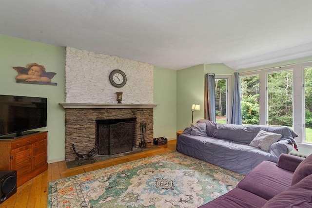 24 Indigo Ln, Osterville, MA 02655 - living room with vaulted ceiling, a stone fireplace, and hardwood / wood-style flooring