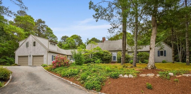 24 Indigo Ln, Osterville, MA 02655 - view of front of home with asphalt driveway, a garage, and a chimney