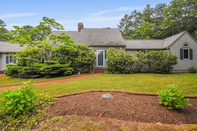 24 Indigo Ln, Osterville, MA 02655 - view of front of house featuring entry steps, a chimney, a front yard, and roof with shingles