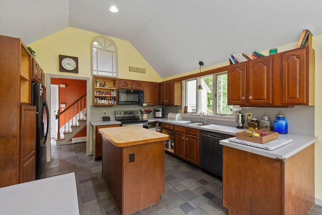 24 Indigo Ln, Osterville, MA 02655 - kitchen with black appliances, a kitchen island, dark stone finish flooring, high vaulted ceiling, and brown cabinetry