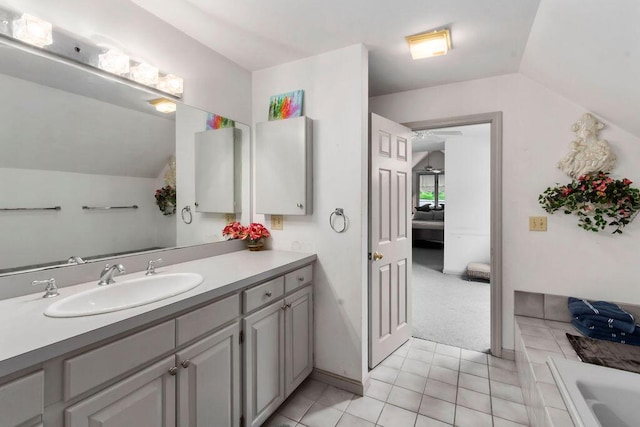24 Indigo Ln, Osterville, MA 02655 - bathroom with vaulted ceiling, vanity, a tub, and tile patterned floors