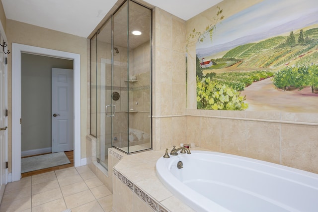 bathroom with tile patterned flooring, a shower stall, a bath, and baseboards