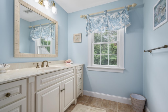 bathroom featuring vanity, tile patterned floors, baseboards, and visible vents