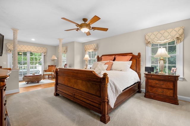 bedroom with ceiling fan, baseboards, light colored carpet, decorative columns, and recessed lighting