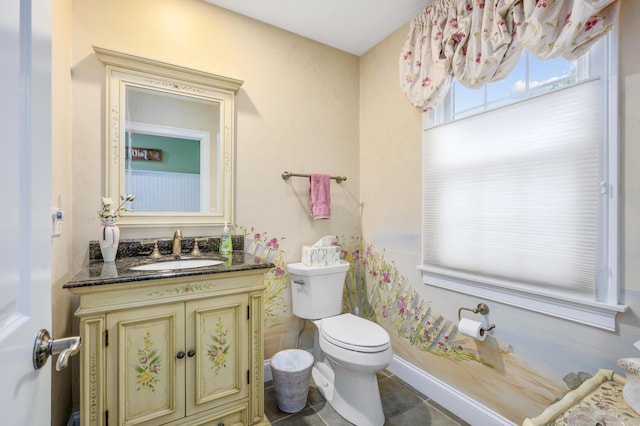 bathroom featuring vanity, tile patterned floors, and toilet