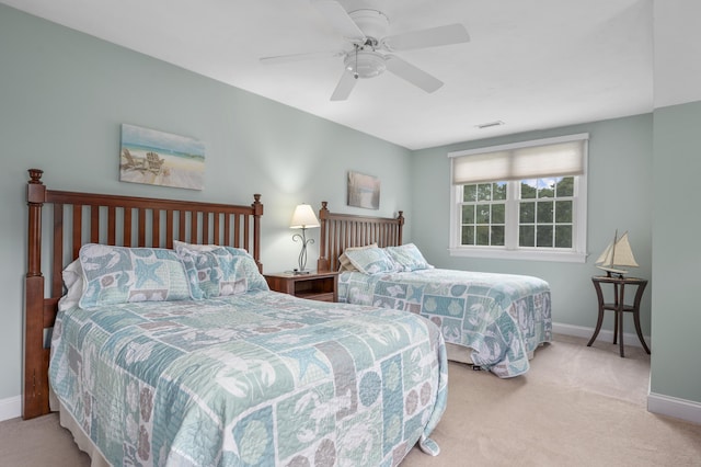 bedroom with a ceiling fan, baseboards, visible vents, and carpet floors
