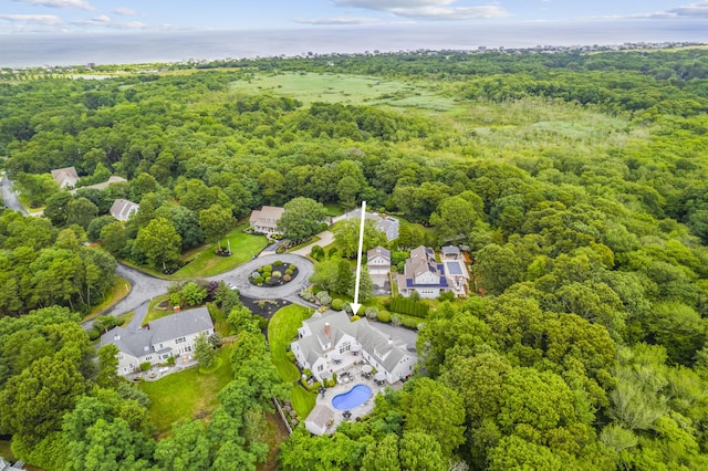 drone / aerial view featuring a view of trees and a residential view
