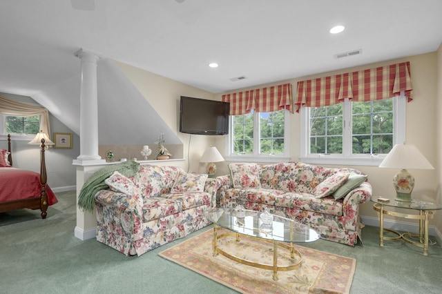 living area featuring decorative columns, carpet, and a wealth of natural light