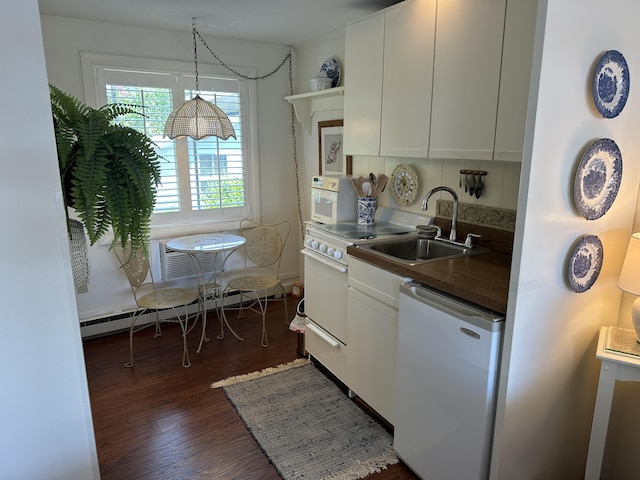 91 Depot St Unit 10, Dennis Port, MA 02639 - kitchen featuring refrigerator, baseboard heating, dark wood-type flooring, white cabinetry, and dark countertops