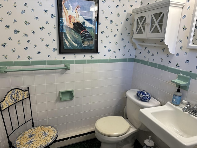 91 Depot St Unit 10, Dennis Port, MA 02639 - bathroom with wallpapered walls, a baseboard radiator, tile walls, and a wainscoted wall