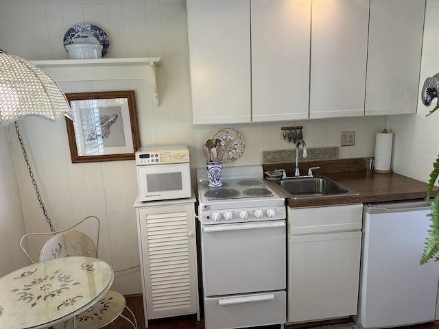 91 Depot St Unit 10, Dennis Port, MA 02639 - kitchen with white appliances, white cabinets, and dark countertops