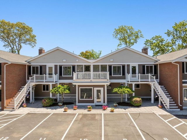 354 Gifford St Unit 1, Falmouth, MA 02540 - view of building exterior with stairway and uncovered parking