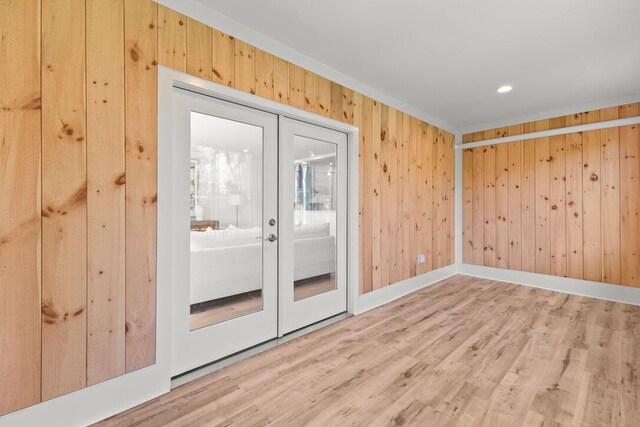 354 Gifford St Unit 1, Falmouth, MA 02540 - unfurnished room featuring french doors, wood walls, light wood-style floors, recessed lighting, and baseboards