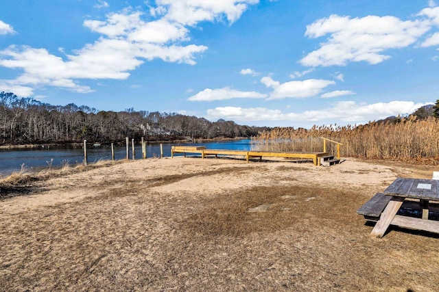 exterior space with a water view and a wooded view