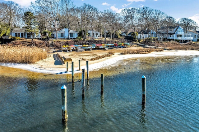 view of dock with a water view and a residential view