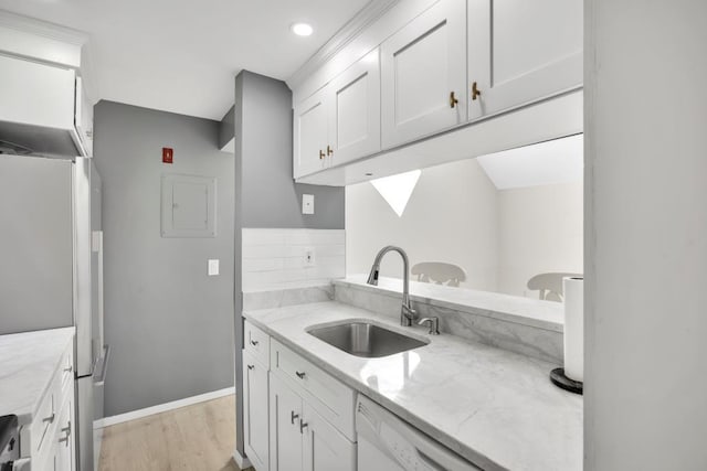 kitchen featuring sink, white cabinets, stainless steel fridge, and light stone counters