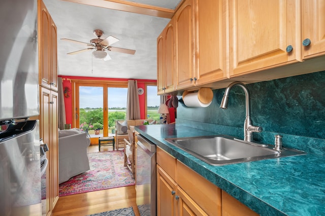 16 Gulls Cove Rd, West Yarmouth, MA 02673 - kitchen with appliances with stainless steel finishes, a ceiling fan, dark countertops, and light wood-style flooring