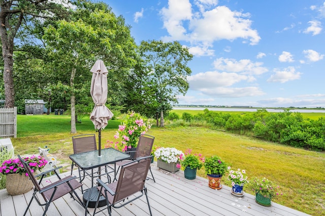 16 Gulls Cove Rd, West Yarmouth, MA 02673 - wooden terrace with a yard, outdoor dining area, and a water view