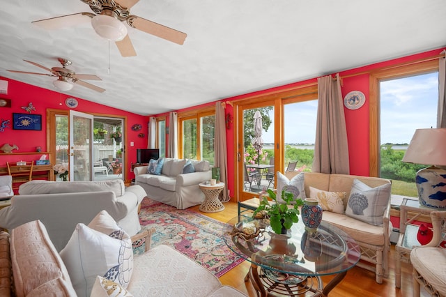 16 Gulls Cove Rd, West Yarmouth, MA 02673 - living area with healthy amount of natural light, lofted ceiling, wood finished floors, and a ceiling fan