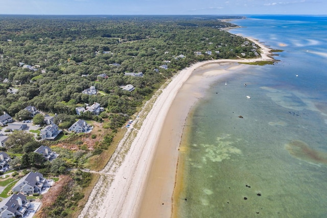 birds eye view of property featuring a water view, a beach view, and a wooded view
