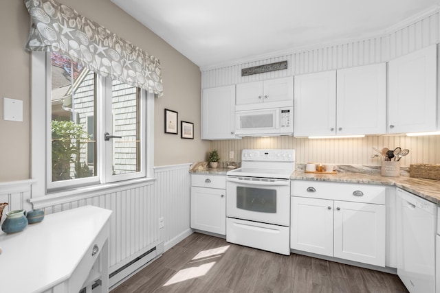 kitchen with a wainscoted wall, white cabinets, baseboard heating, and white appliances