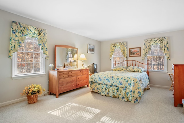 carpeted bedroom with multiple windows