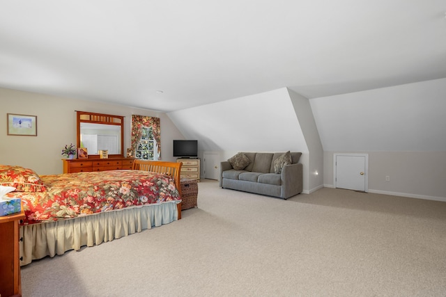 carpeted bedroom featuring lofted ceiling